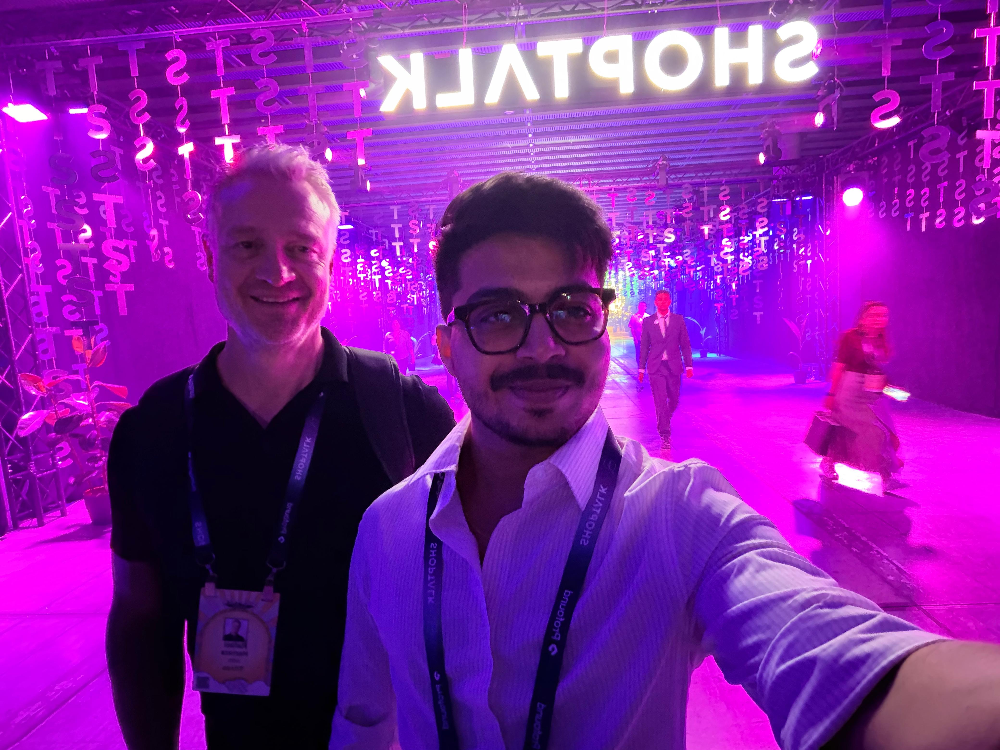 Trivas teammates under the Shoptalk sign